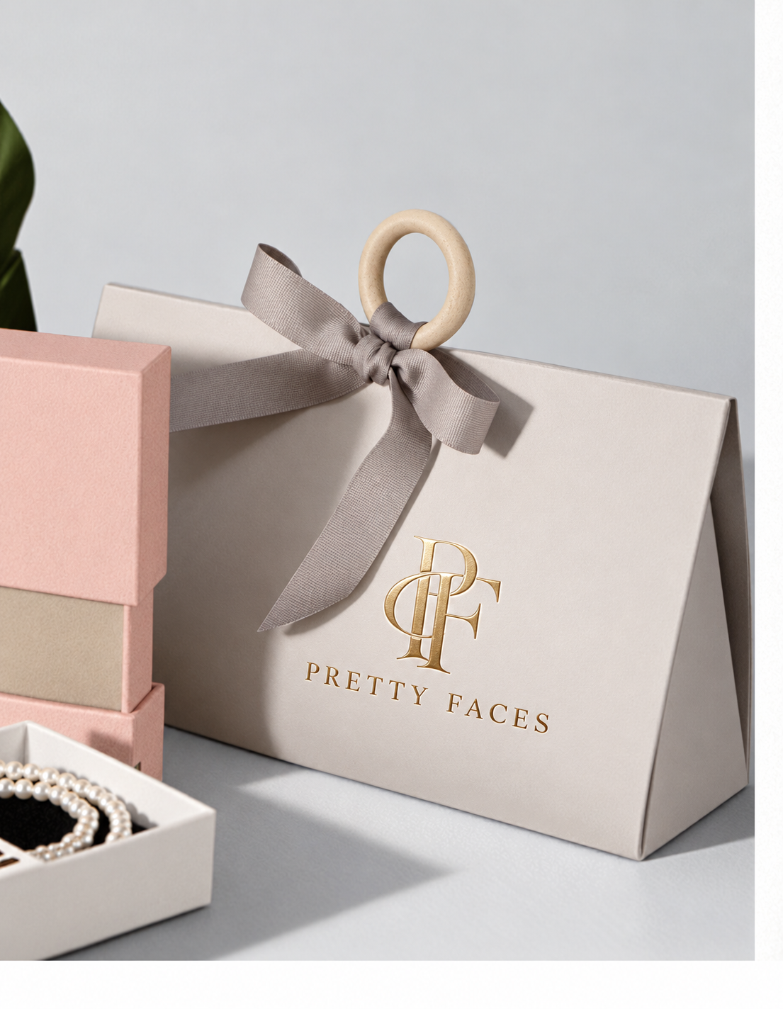 Pretty Faces branded gift packaging with a satin ribbon